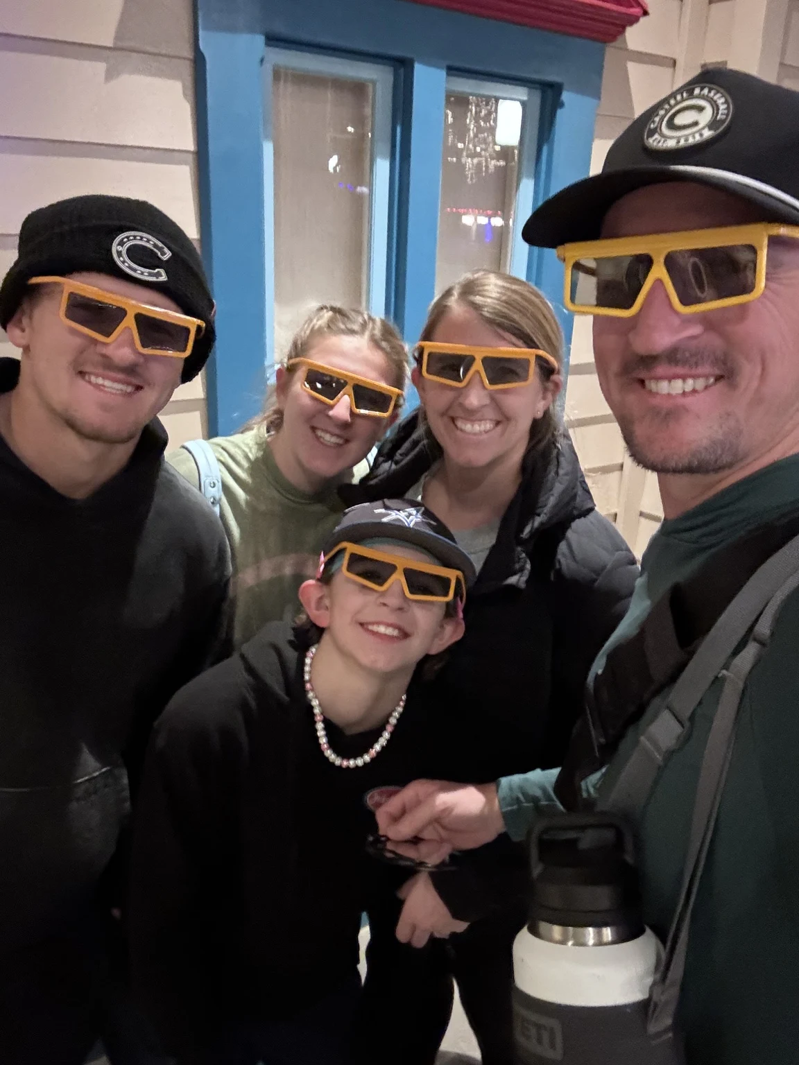 The Harwoods in caps and sunglasses during a family outing