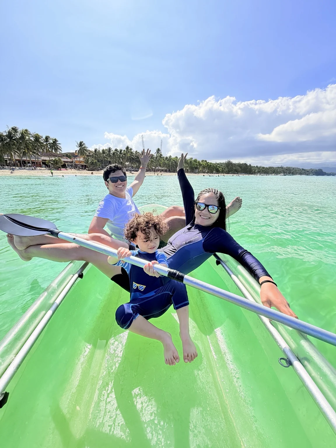 Justin, Charlene and Simon enjoying the turquoise water together in a clear kayak