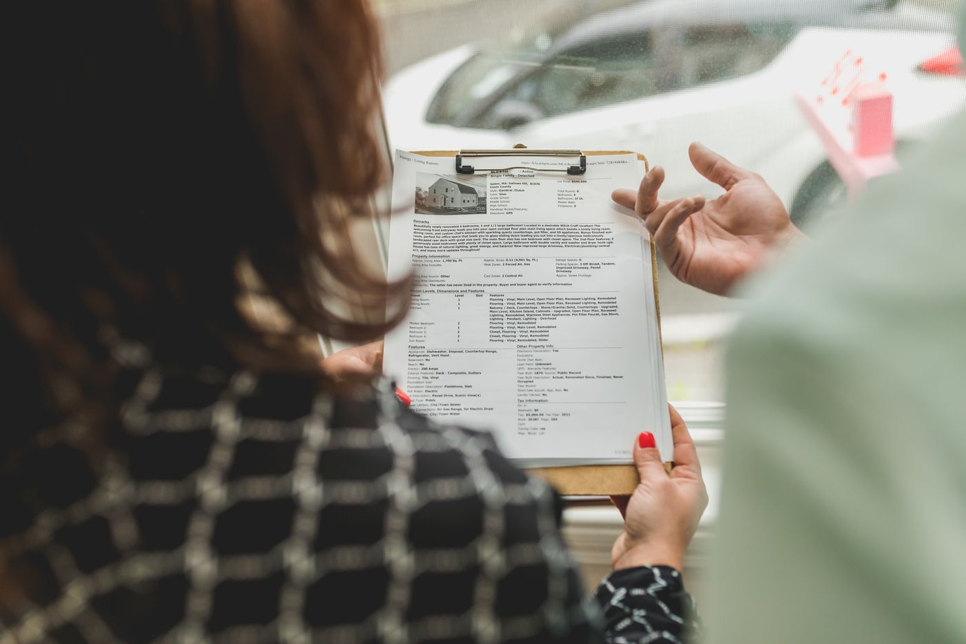 A property professional reviewing documents on a clipboard