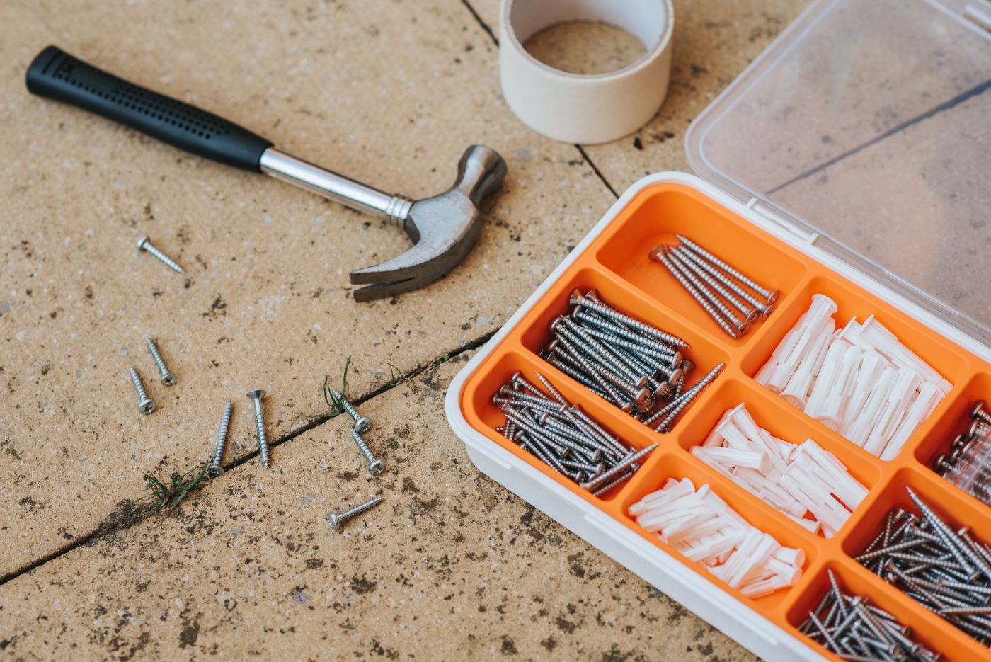 Repair toolkit with screws, anchors, tape and a hammer