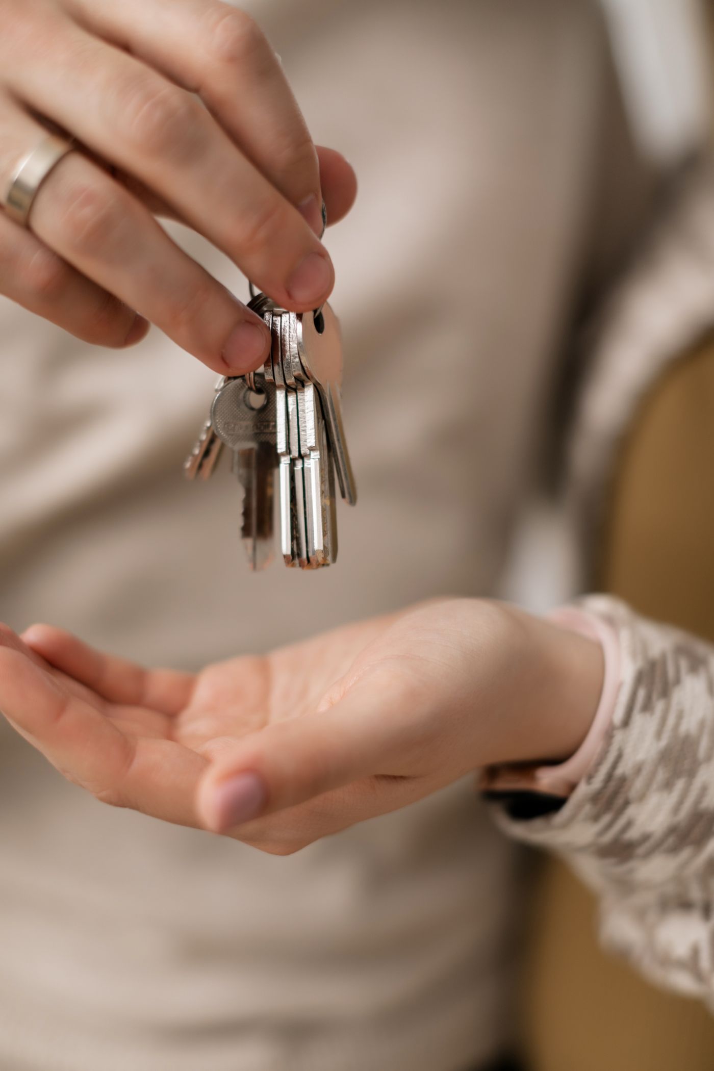 Hands exchanging the keys to a home