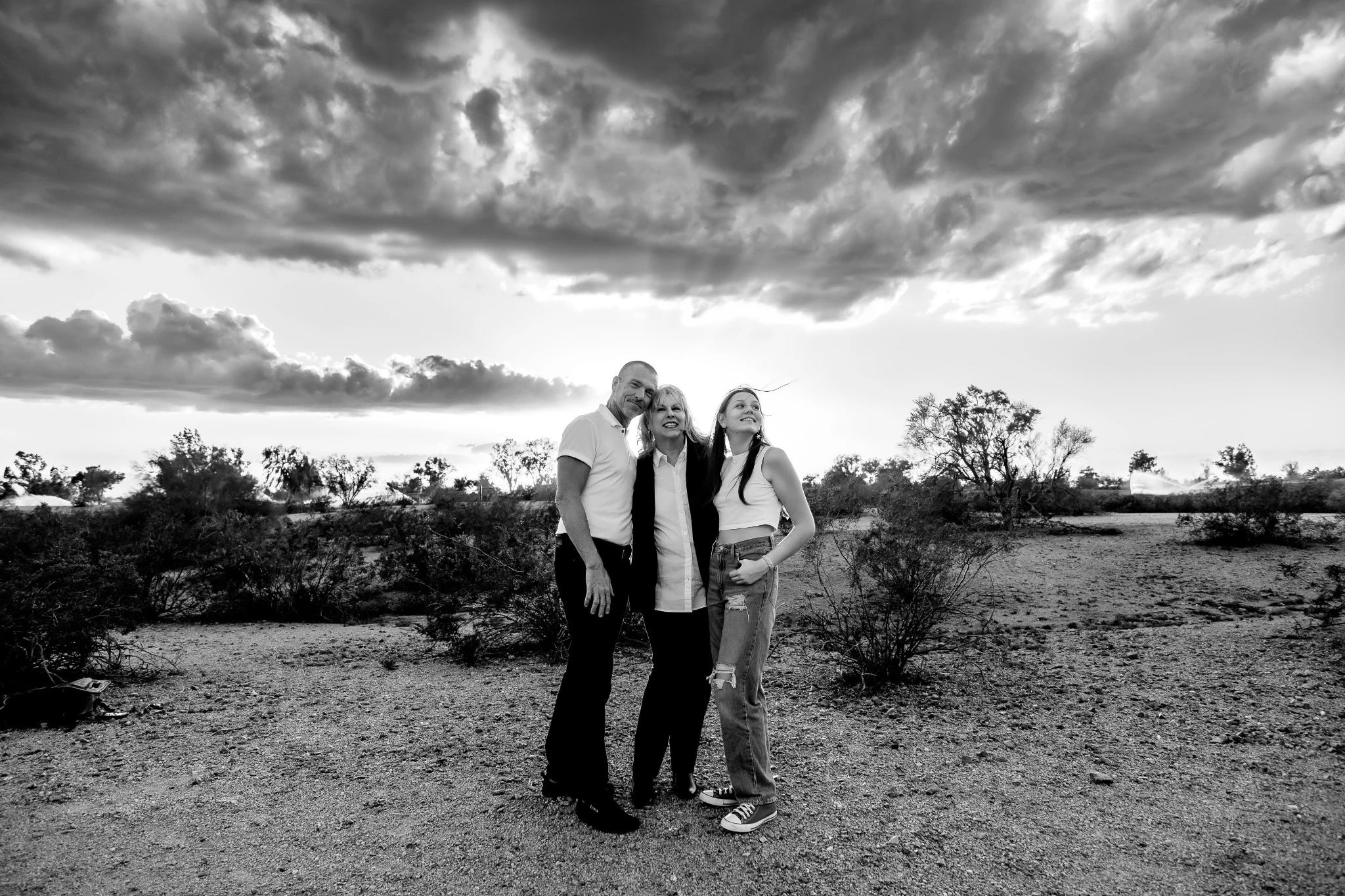 Paul, Judy and Reese together beneath a dramatic Arizona sky