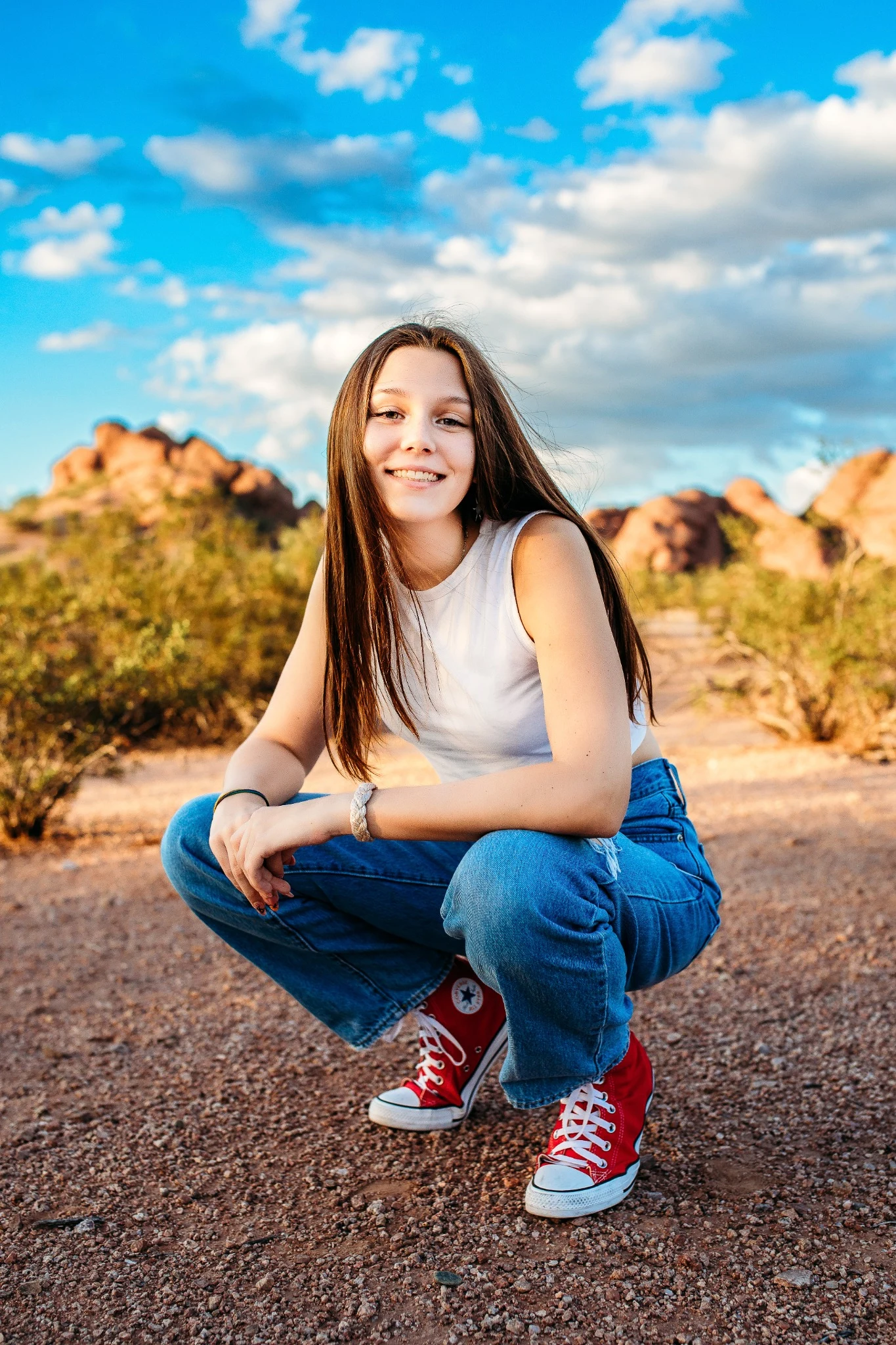 Reese seated on a rock in the Arizona desert